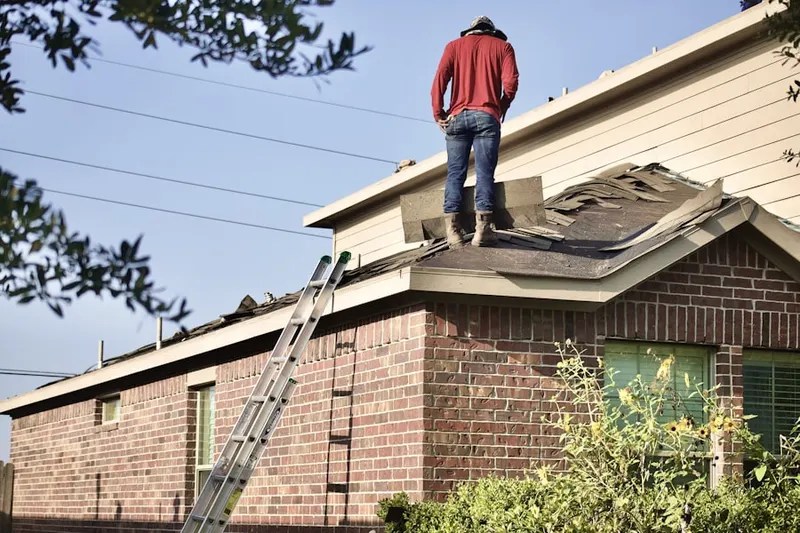 Professional roofer working on a residential roof in Heights
